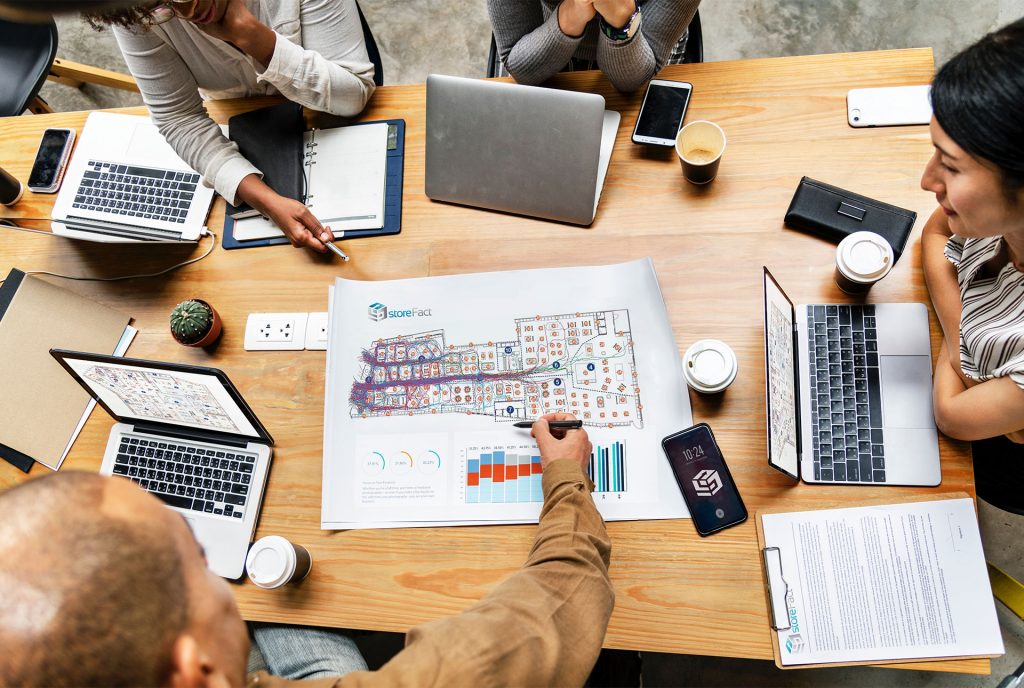 People around conferance table planning store layout